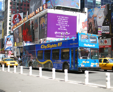 The CitySights bus travels through Times Square.  Photo by Hal Wiener, from A View From the Bus, A Tour Guide Takes Manhattan,  by Carla Stockton, Felicia Brings and Hal Wiener.